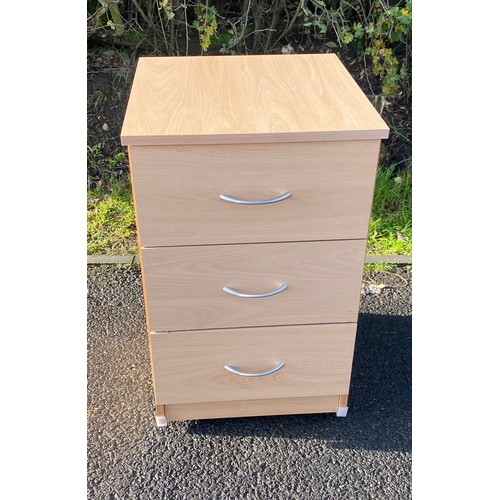 610 - 3 drawer maple effect bedside table on casters, measures approx 25 inches tall 22 inches depth