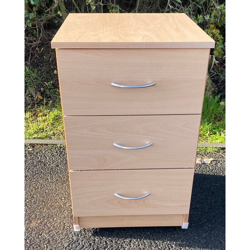 610 - 3 drawer maple effect bedside table on casters, measures approx 25 inches tall 22 inches depth