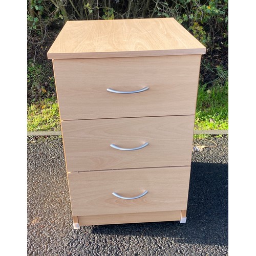 610 - 3 drawer maple effect bedside table on casters, measures approx 25 inches tall 22 inches depth