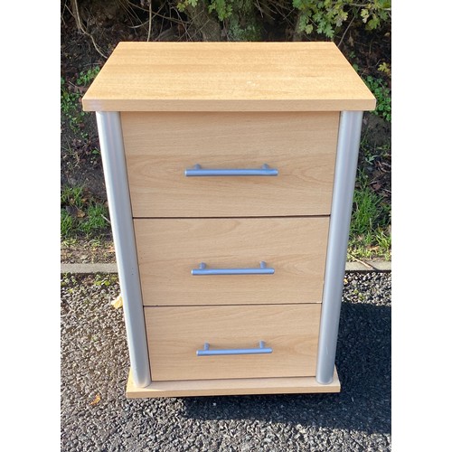 609 - 3 drawer maple effect bedside table on casters, measures approx 25 inches tall 22 inches depth