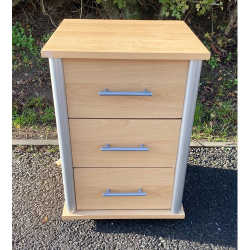 609 - 3 drawer maple effect bedside table on casters, measures approx 25 inches tall 22 inches depth