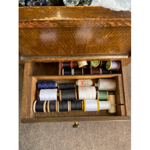 611 - Vintage oak sewing box with a large selection of assorted sewing items