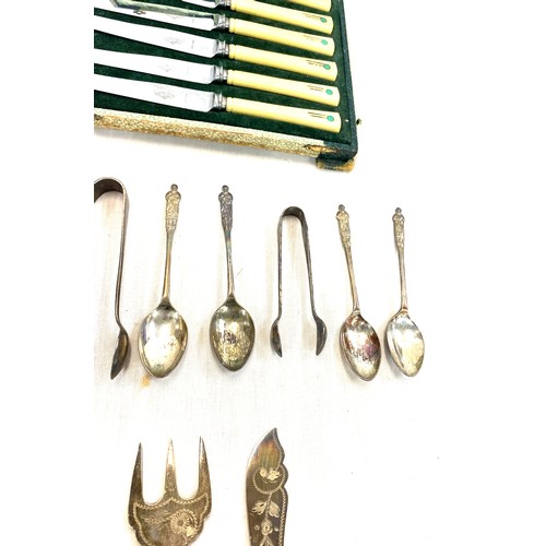 83 - Selection of silver plated cutlery includes art deco knife set