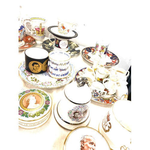 291 - Large selection of commemorative ware includes mugs, bells etc