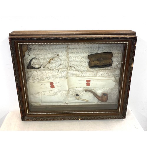 234 - Cased diorama includes spectacles and smoking pipes, case measures approx 16 inches by 21 inches