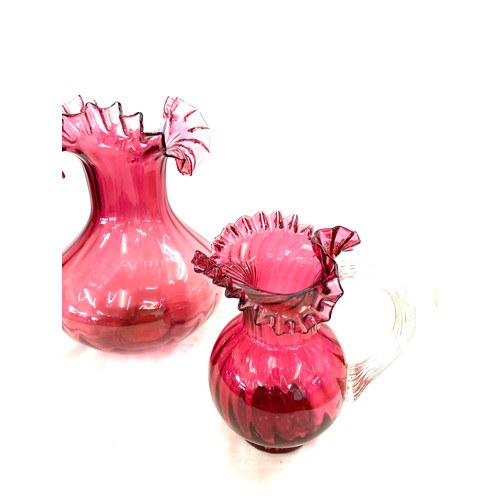 2 - Cranberry glass vase and jug, approximate height of vase: 11.5 inches