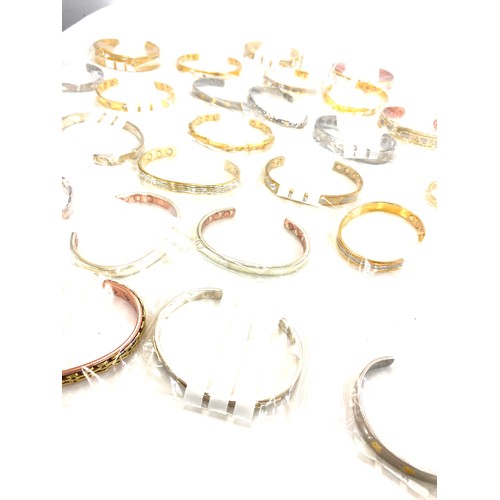 216 - Large selection of mens magnetic bangles, assorted styles etc