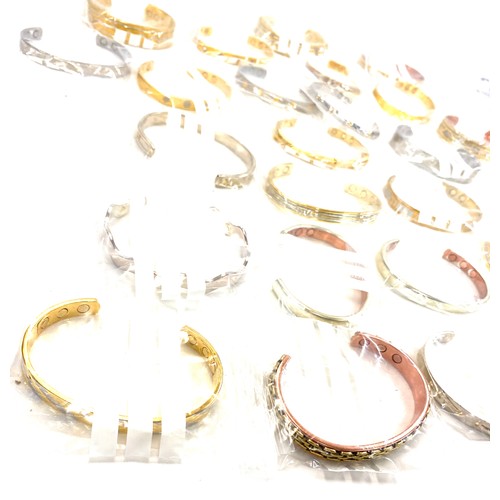 216 - Large selection of mens magnetic bangles, assorted styles etc