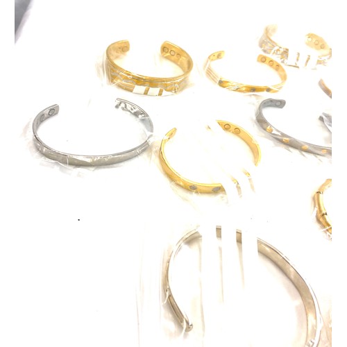 216 - Large selection of mens magnetic bangles, assorted styles etc