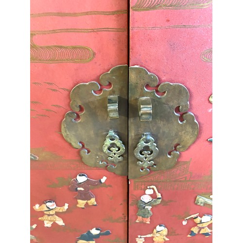 356 - 2 Door red lacquered Chinese inlayed cabinet with 2 internal shelves measures approx 48 inches tall ... 