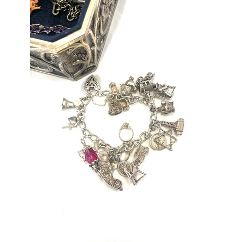 586 - Box of costume jewellery includes silver charm bracelet (some charms not silver), pocket knife, badg... 