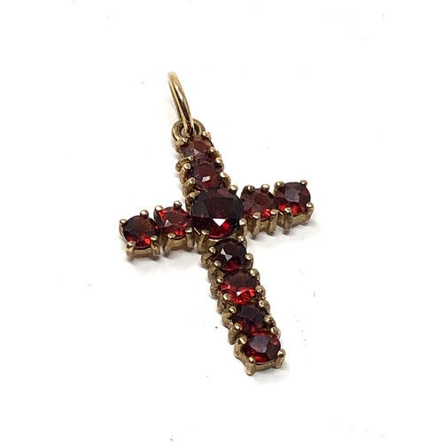 182 - 9ct gold garnet set cross pendant weight 1.2g