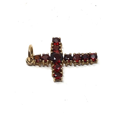 182 - 9ct gold garnet set cross pendant weight 1.2g