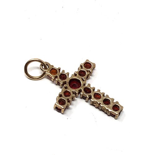 182 - 9ct gold garnet set cross pendant weight 1.2g