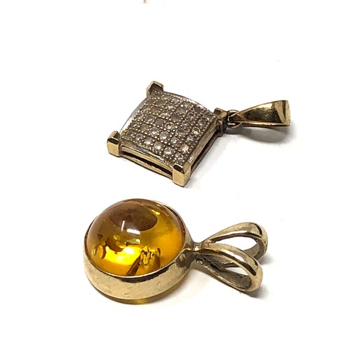 189 - 2 9ct gold pendants diamond & amber weight 1.6g