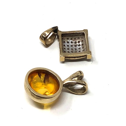 189 - 2 9ct gold pendants diamond & amber weight 1.6g