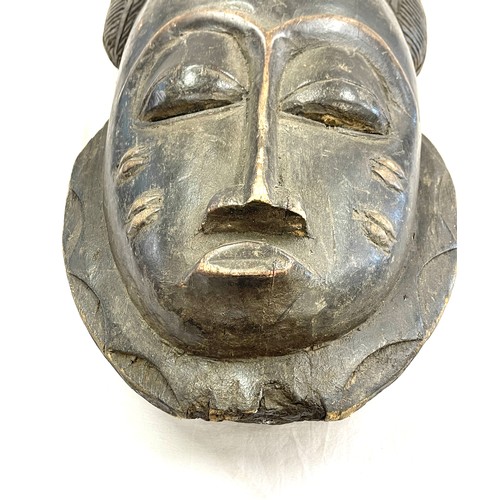 107 - A 19th/early 20th century central/west African ceremonial mask. Good detailing with scarification de... 