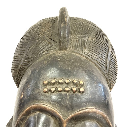 107 - A 19th/early 20th century central/west African ceremonial mask. Good detailing with scarification de... 