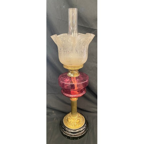 112 - Vintage Nelsons column cranberry font oil lamp, approximate height 26.5 inches