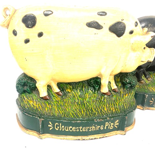 305 - Two cast iron pig door stops measures approx 9.5 inches tall by 12 inches long