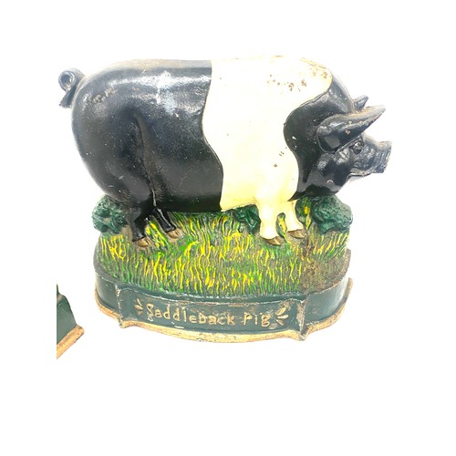 305 - Two cast iron pig door stops measures approx 9.5 inches tall by 12 inches long