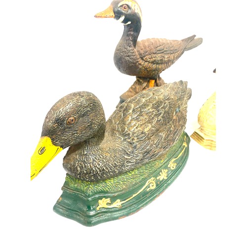 310 - Three cast iron door stops two ducks and one swan largest measures approx 15 inches long and 8 inche... 