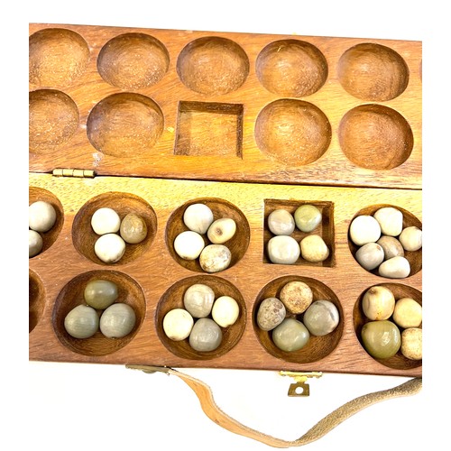 120 - A vintage Mancala wooden board game. The hand carved wooden case opens to be used as a board game wi... 