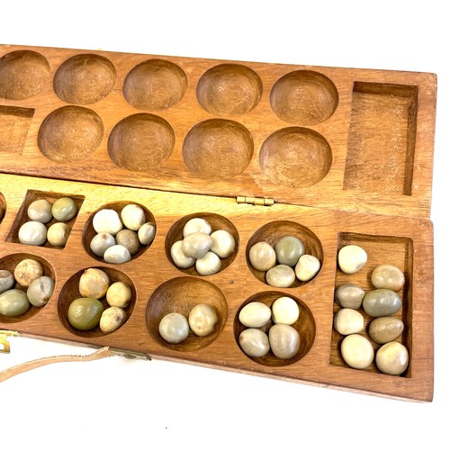 120 - A vintage Mancala wooden board game. The hand carved wooden case opens to be used as a board game wi... 