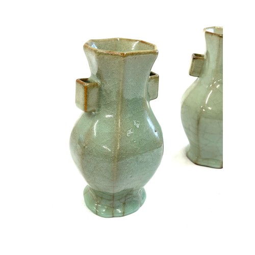 125 - A pair of Faceted vases in Hu form with celadon glaze. The pair of vases are in 18th century style w... 