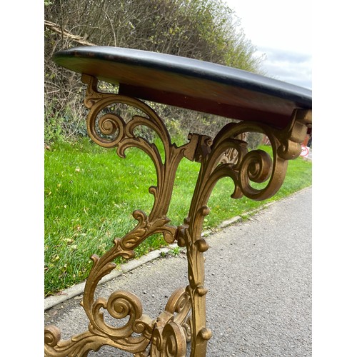 139 - Early 19th century heavy cast iron pub table with mahogany top, the cast iron foliate scroll tri-tor... 