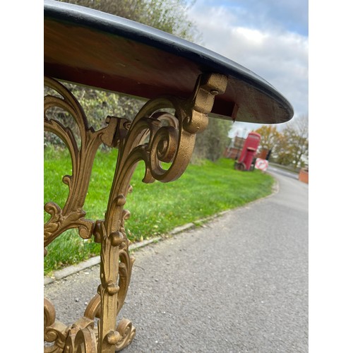 139 - Early 19th century heavy cast iron pub table with mahogany top, the cast iron foliate scroll tri-tor... 