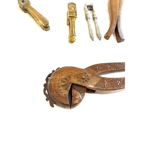 302 - Large selection of novelty nut crackers include carved wooden, brass etc