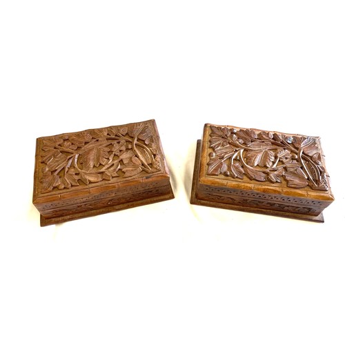 142 - Pair of vintage wooden carved cigarette boxes, each measures approx 3 inches tall 8 inches wide