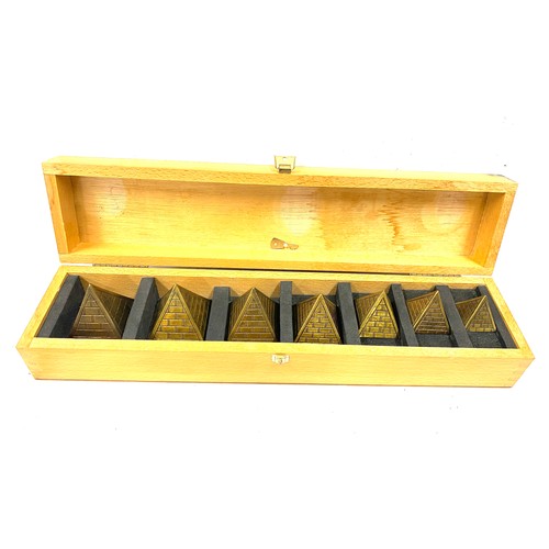 94 - Cased set of Brass Pyramid paper weights