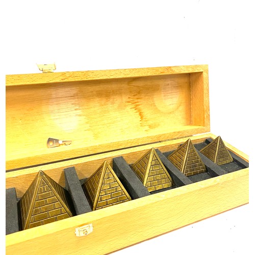 94 - Cased set of Brass Pyramid paper weights