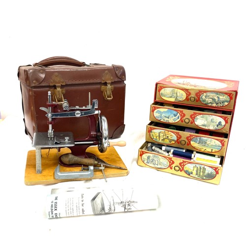 19 - Vintage cased Essex miniature sewing machine and a selection of cotton reels