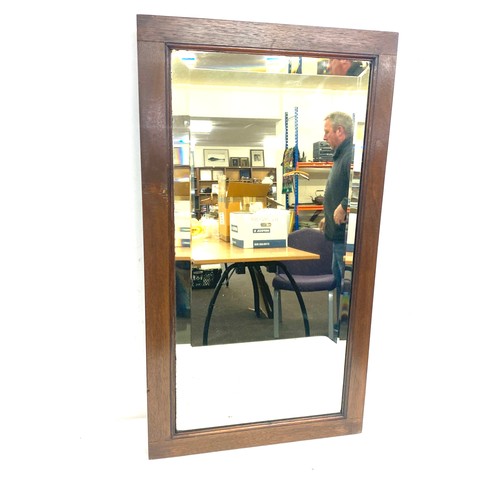 318 - Small solid oak framed mirror, approximate frame measurements: 25 x 15 inches