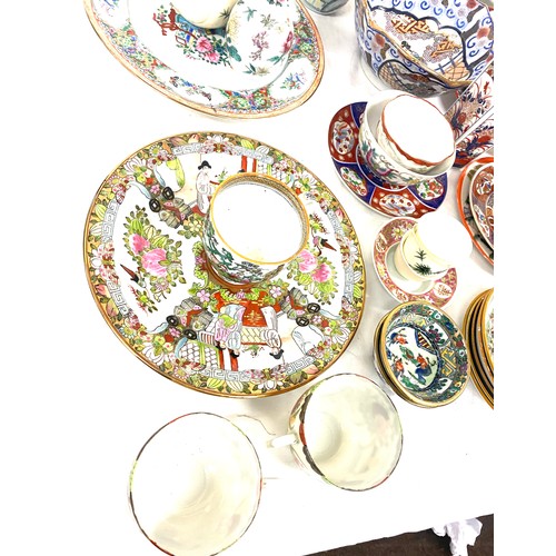 221 - Large selection of oriental pottery pieces to include plates, bowls, cups etc