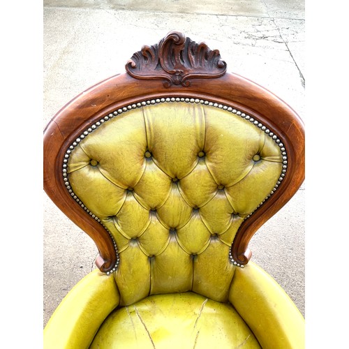 384 - Leather and mahogany nursing chair, button back