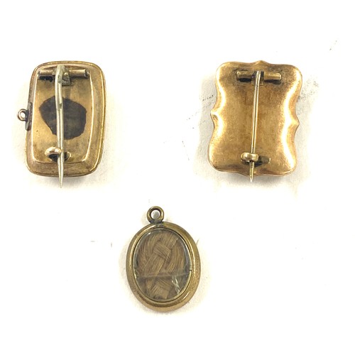 447 - 2 Georgian brooches plus a pendant charm possibly gold, gross weight 6.3g