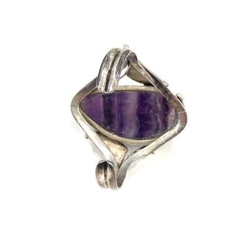 428 - Large heavy silver bangle with large purple quartz stone, marked 925, approximate weight 112g