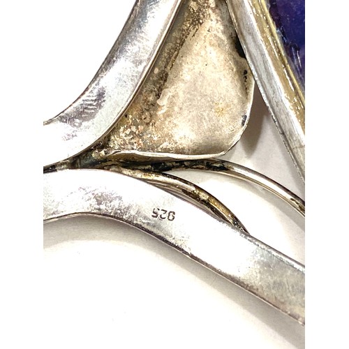 428 - Large heavy silver bangle with large purple quartz stone, marked 925, approximate weight 112g