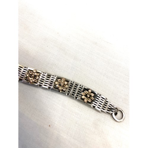 516 - Silver bracelet with yellow metal flowers attached including safety chain