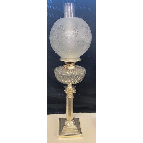 100C - Antique silver plated Nelson column oil lamp, glass shade and font, approximate height 27 inches