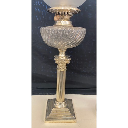 100C - Antique silver plated Nelson column oil lamp, glass shade and font, approximate height 27 inches