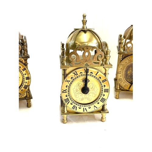 46 - Three vintage brass roman numerical clocks. Measures approx 7.5 inches high- Untested