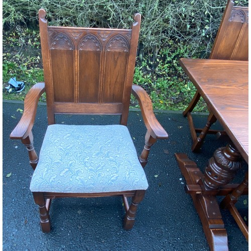 355 - Solid Oak gothic style table and 6 chairs has been repolished, (includes 2 carvers), chairs with uph... 