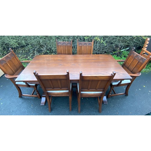 355 - Solid Oak gothic style table and 6 chairs has been repolished, (includes 2 carvers), chairs with uph... 