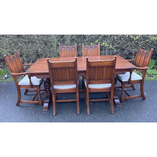 355 - Solid Oak gothic style table and 6 chairs has been repolished, (includes 2 carvers), chairs with uph... 