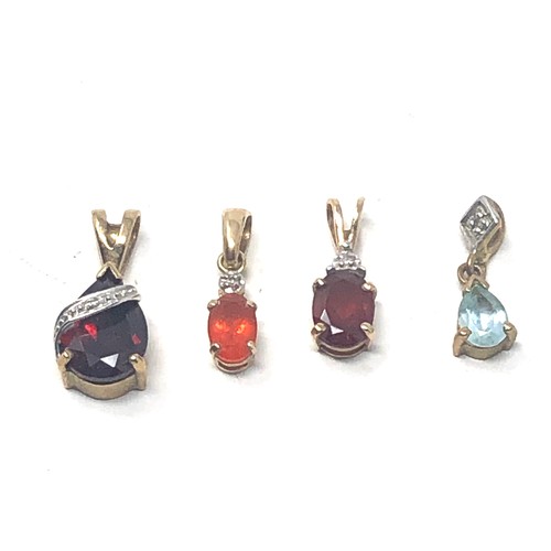 111 - 4 x 9ct gold gemstone pendants inc. garnet, topaz & diamond (2.6g)